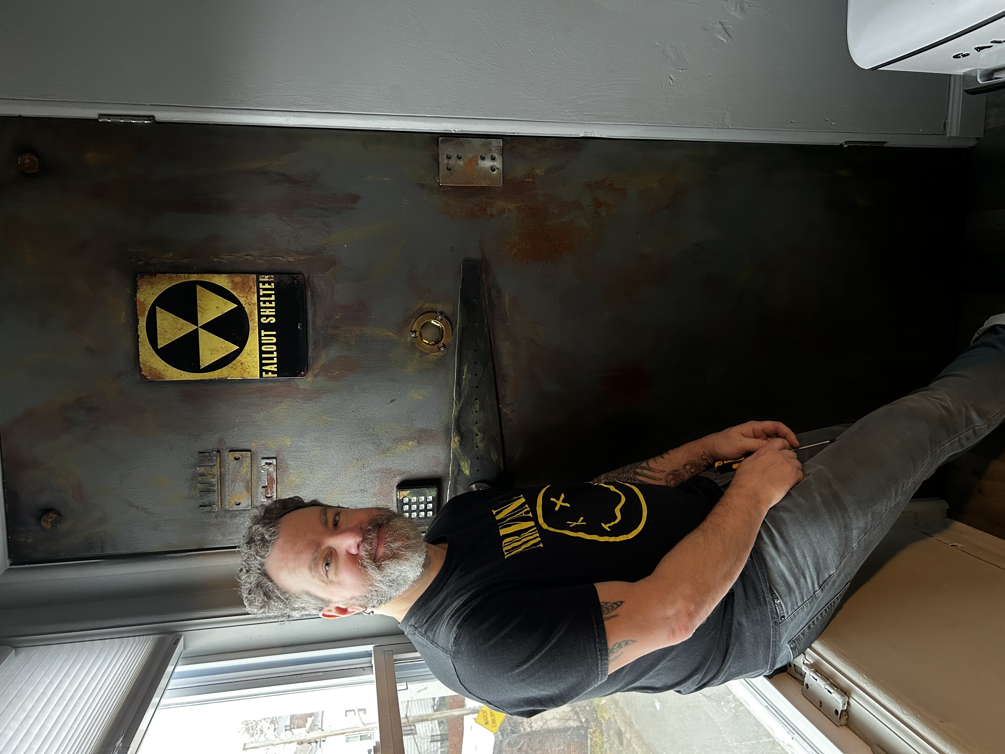 Scott Kowalski and Lauren DeMichiei Transform a Gray Door into a Fallout Shelter Door  for a Gaming Haven